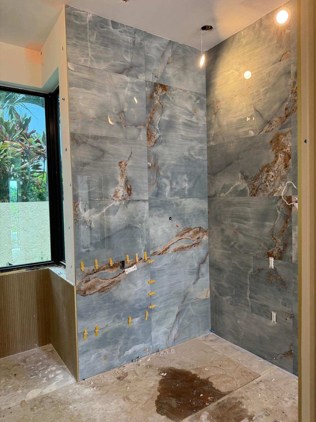 Book-matched quartzite feature wall with the veining continued across the corner