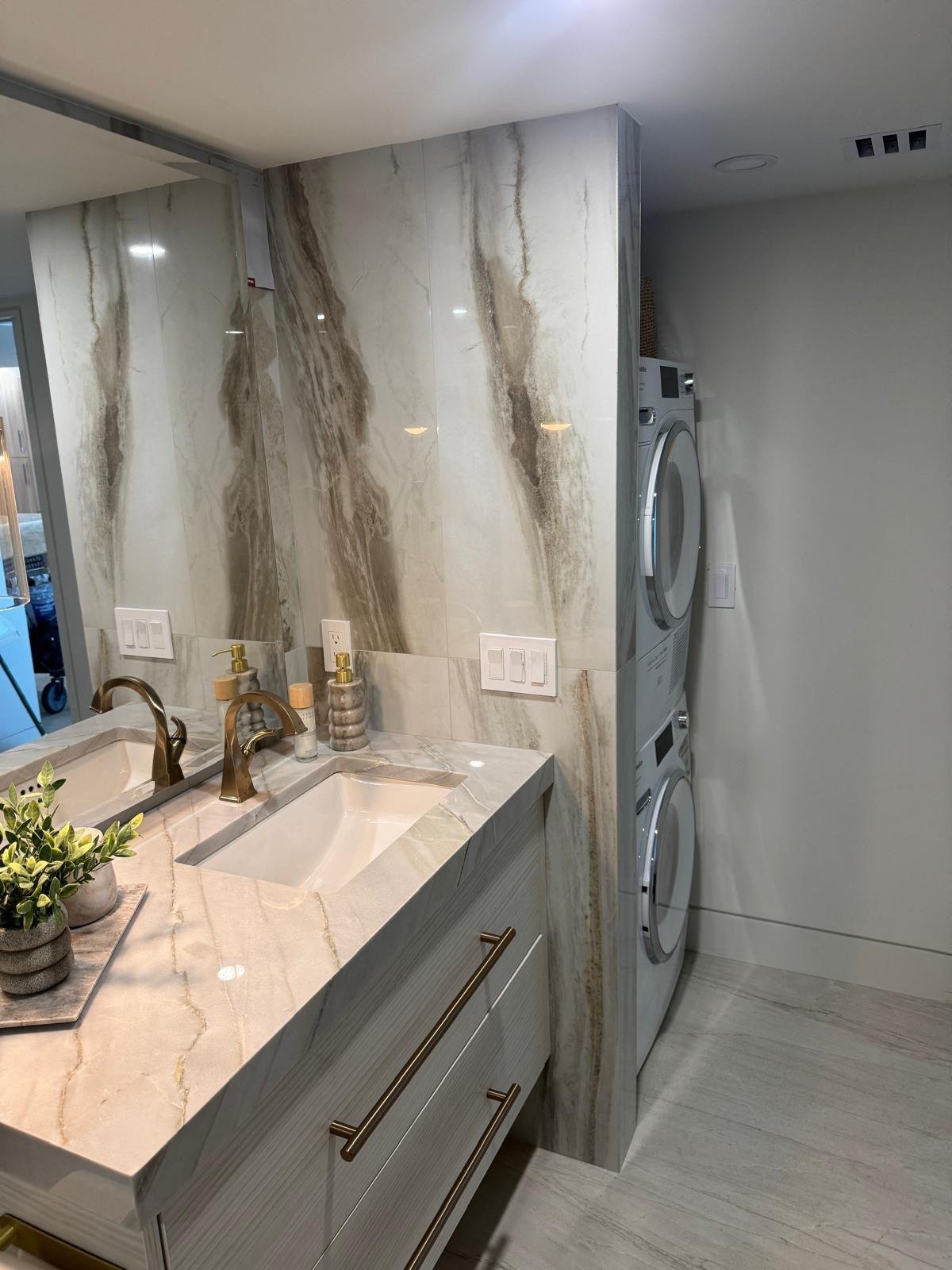 Luxury bathroom vanity with marble countertop and veined stone wall