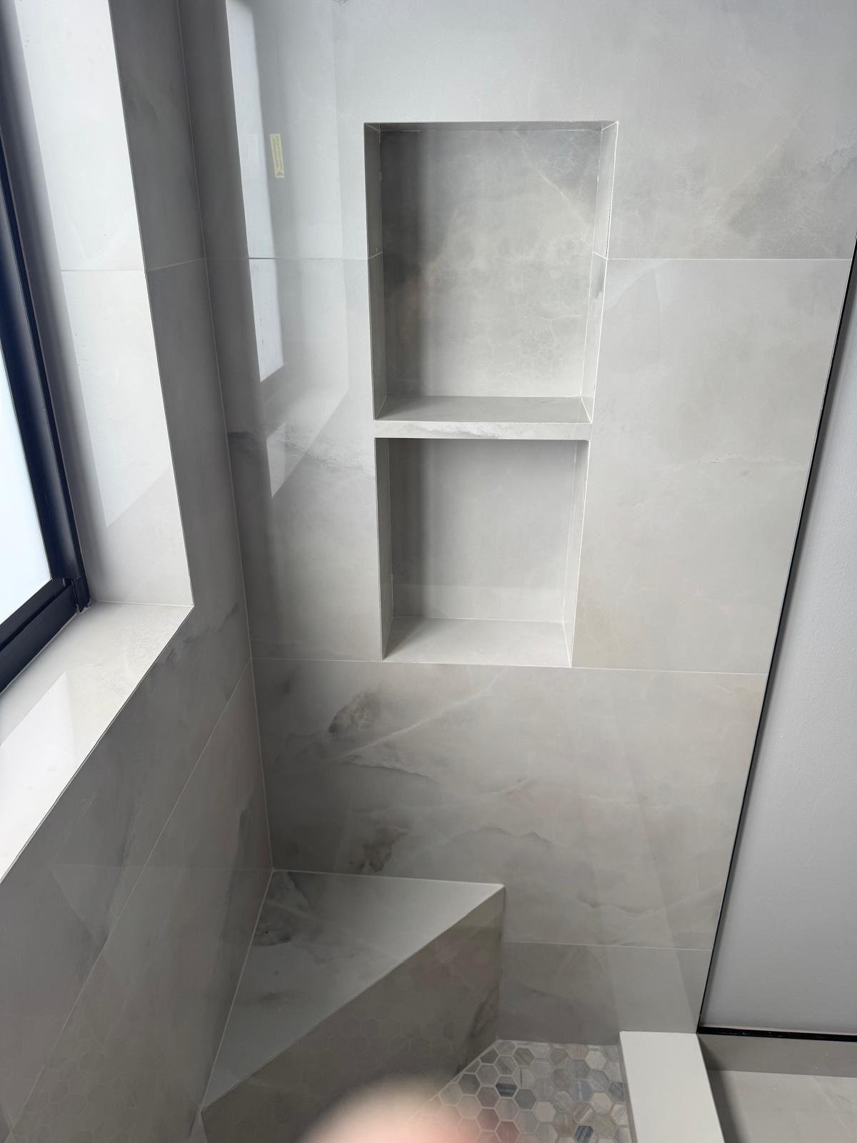 Marble shower niche and built-in corner bench