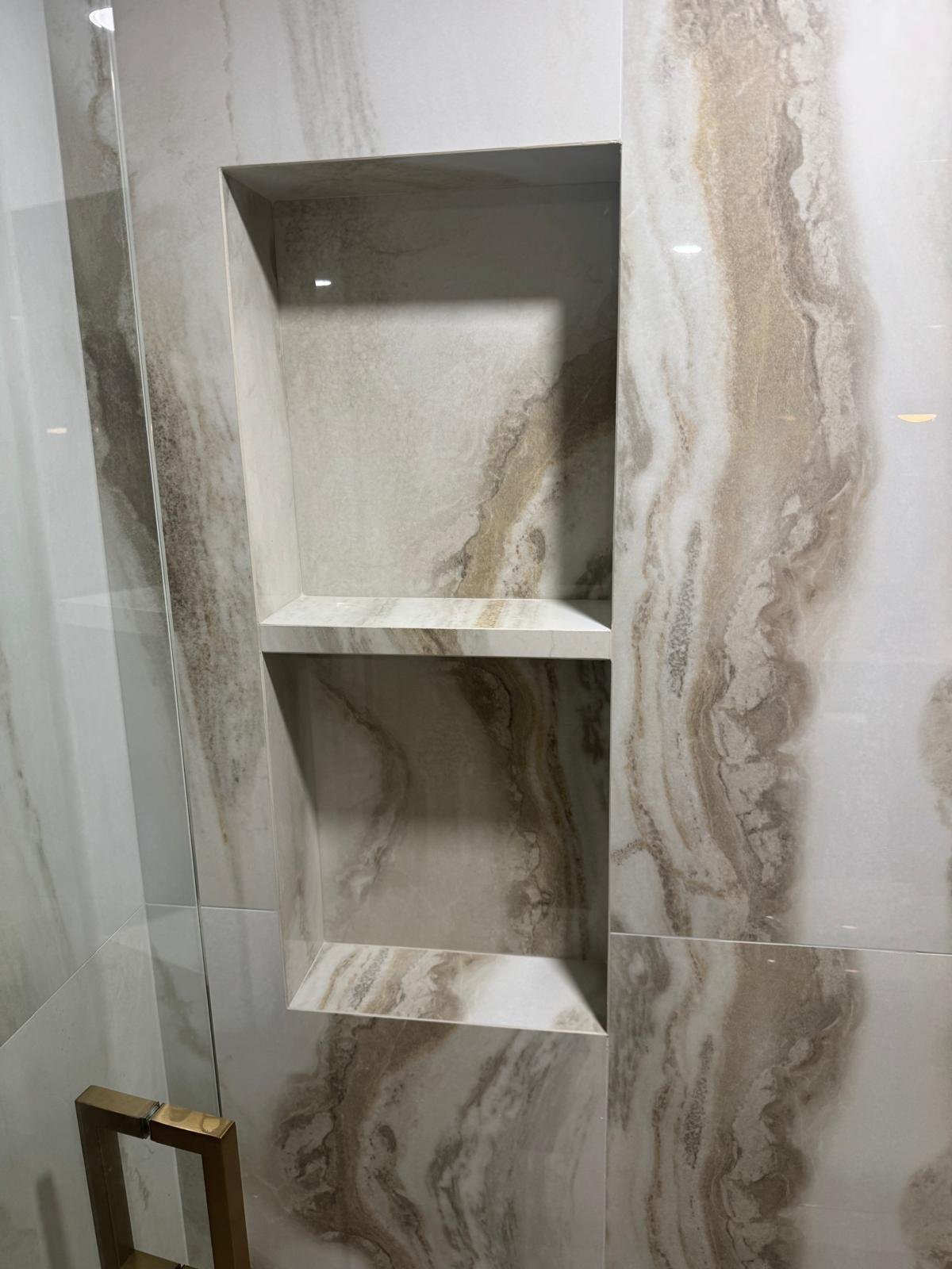 Marble shower niche with the stone veining matched across the opening