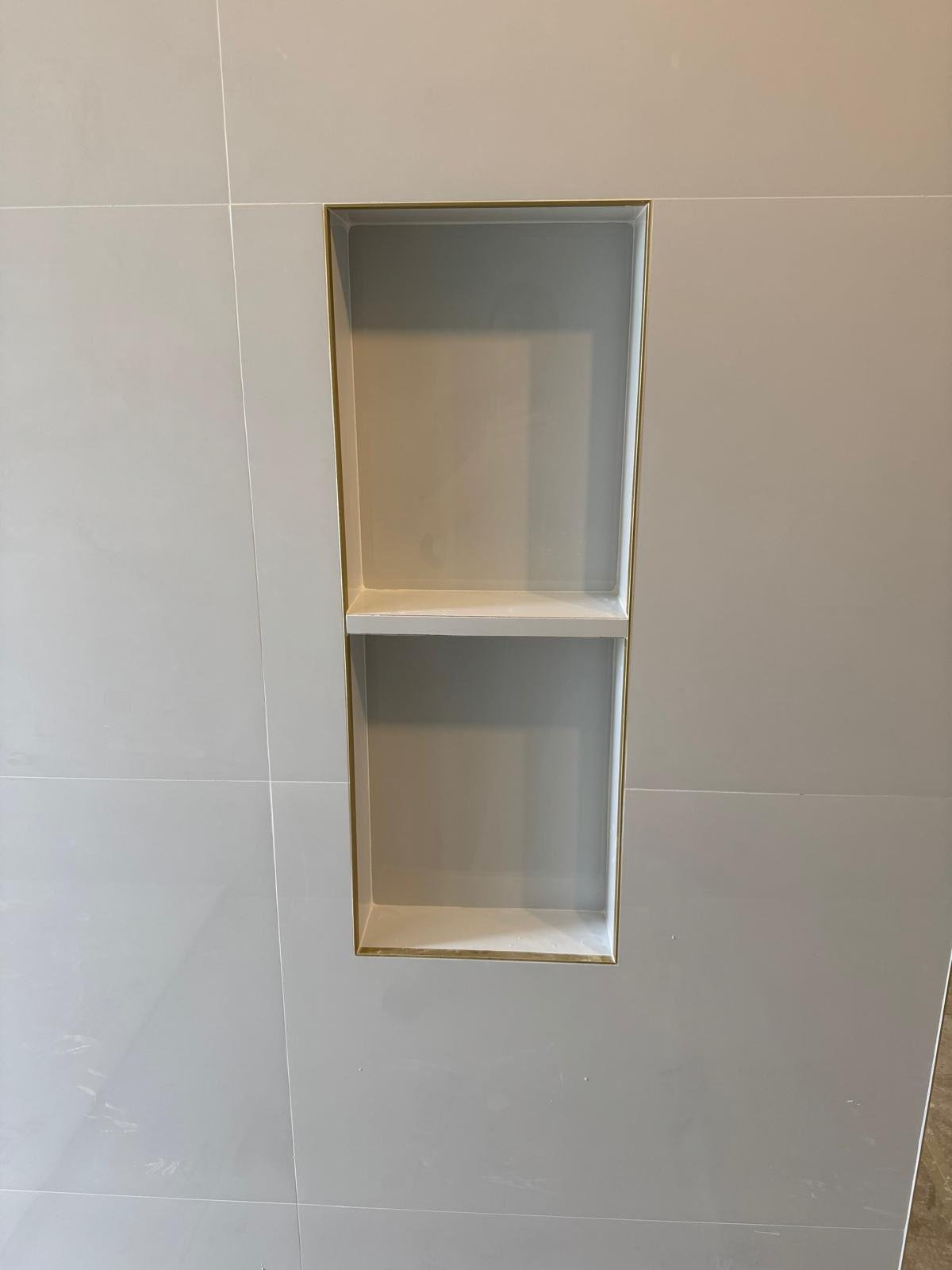 Recessed shower niche framed in large-format porcelain