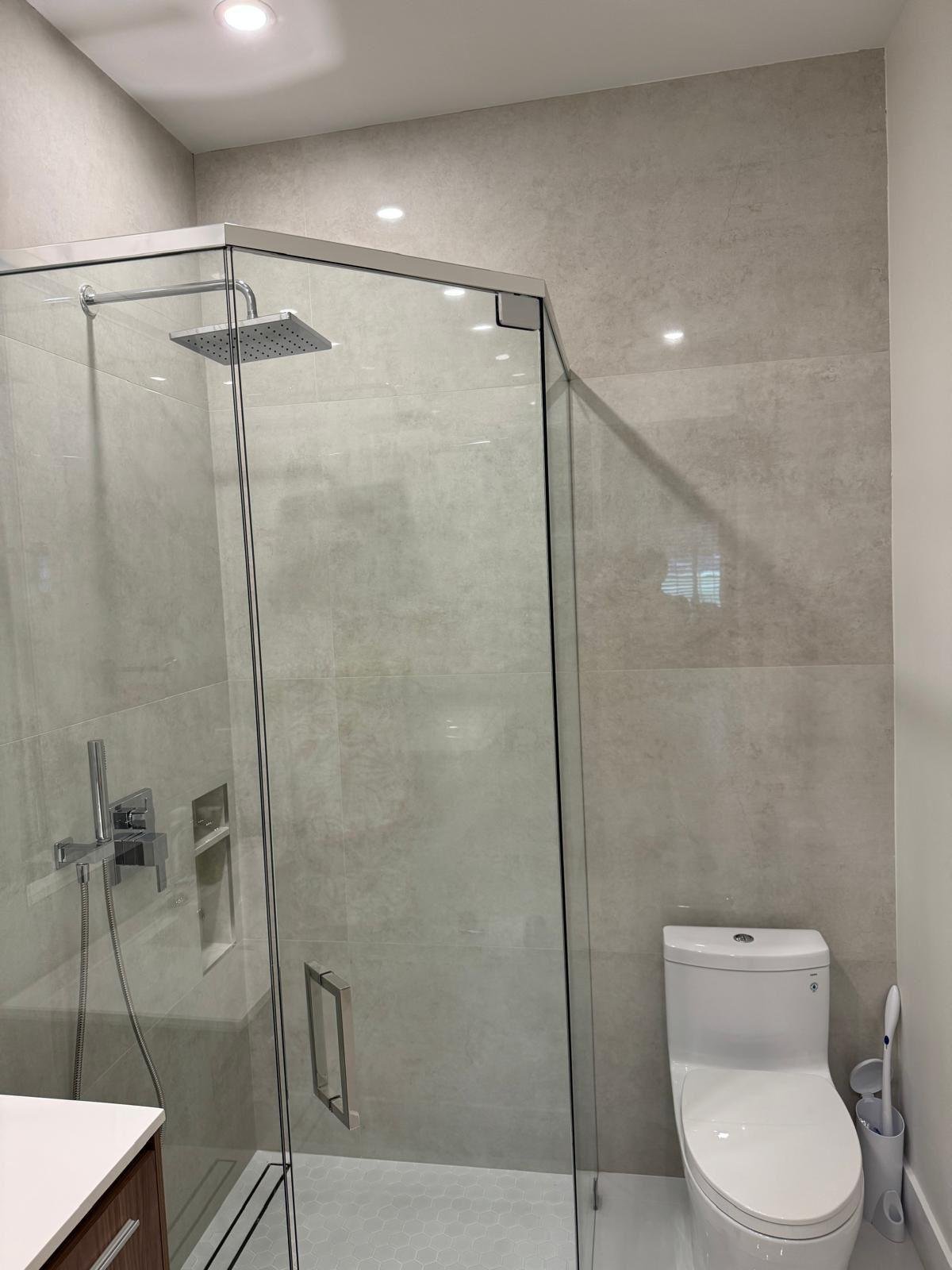 Walk-in glass shower in a completed modern bathroom remodel